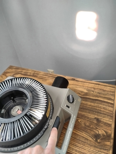 Kodak projector with slide tray displaying an image